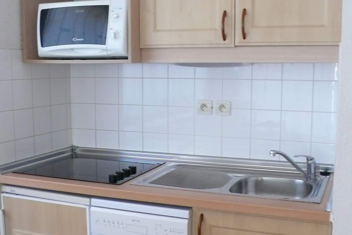 Eine Küche mit Mikrowelle, Geschirrspüler und einer doppelten Spüle.