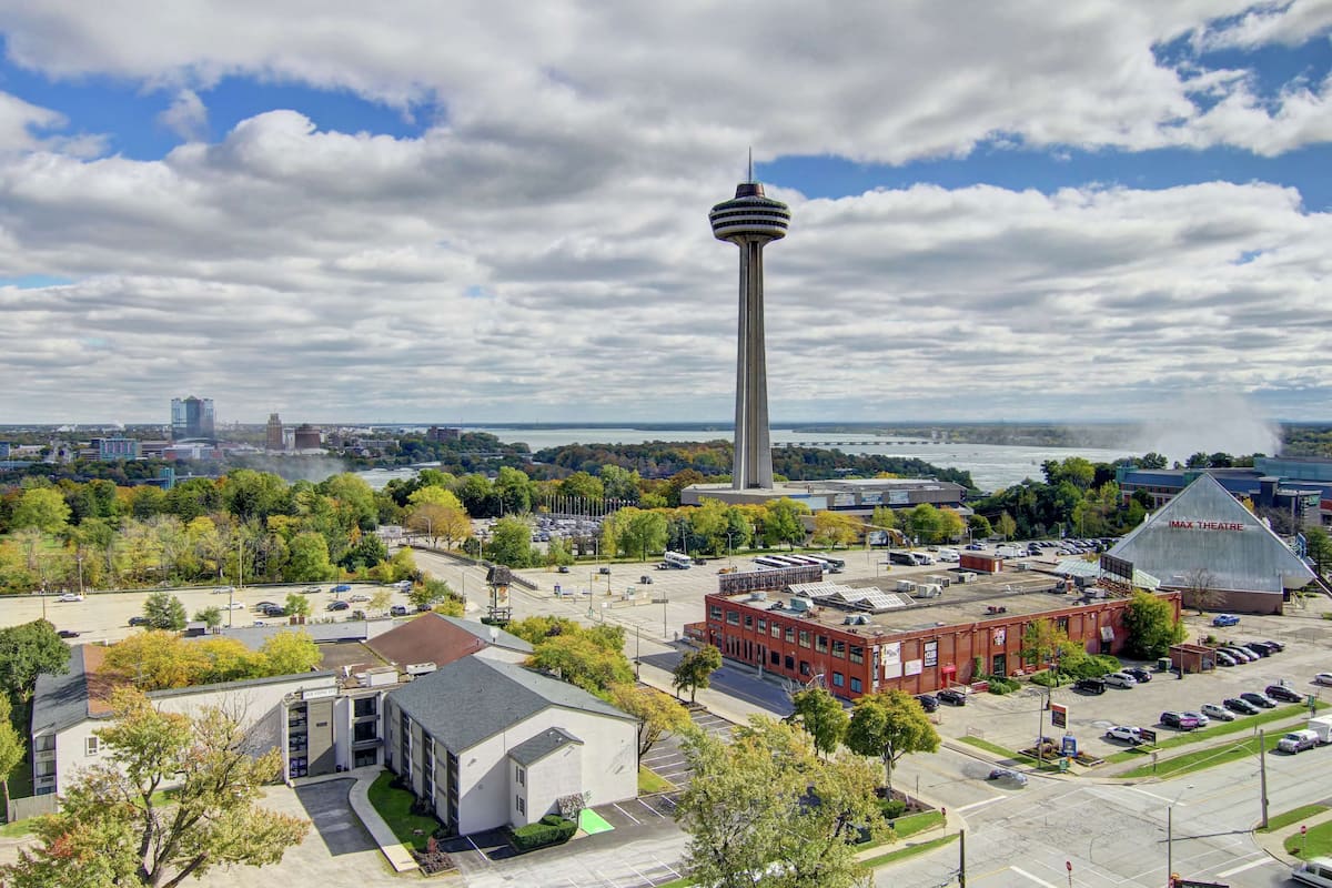 A cityscape with a prominent tower, a parking lot, and a building labeled "MAXX Theatre".