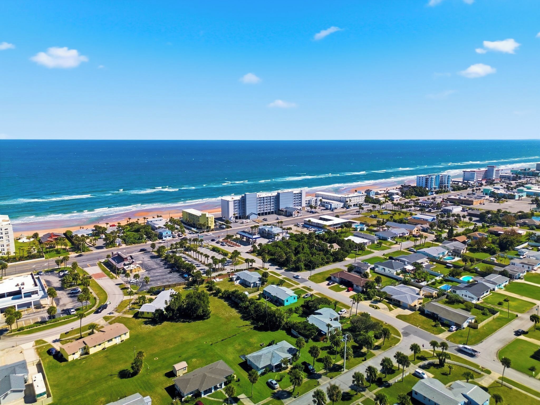 A coastal town with a beachfront, residential areas, and commercial buildings.