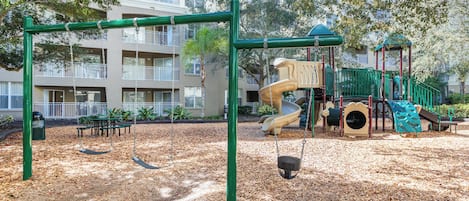 A playground with swings, slides, and climbing structures.
