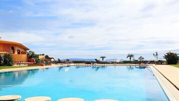 Indoor pool, outdoor pool, pool umbrellas, pool loungers