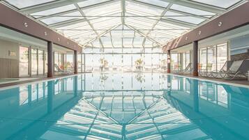 Indoor pool, pool umbrellas, pool loungers