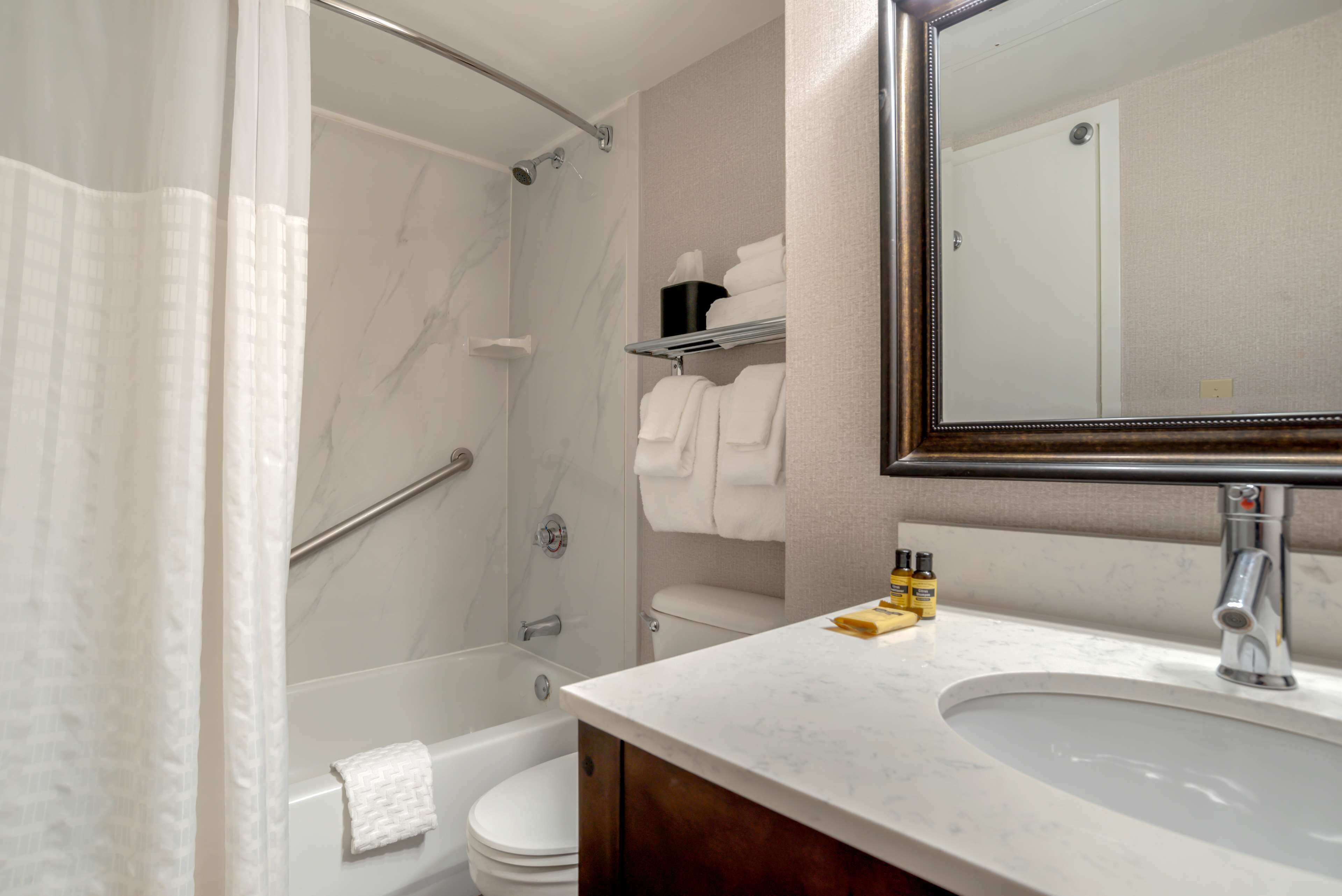 combined shower/bathtub, designer toiletries, hair dryer, towels