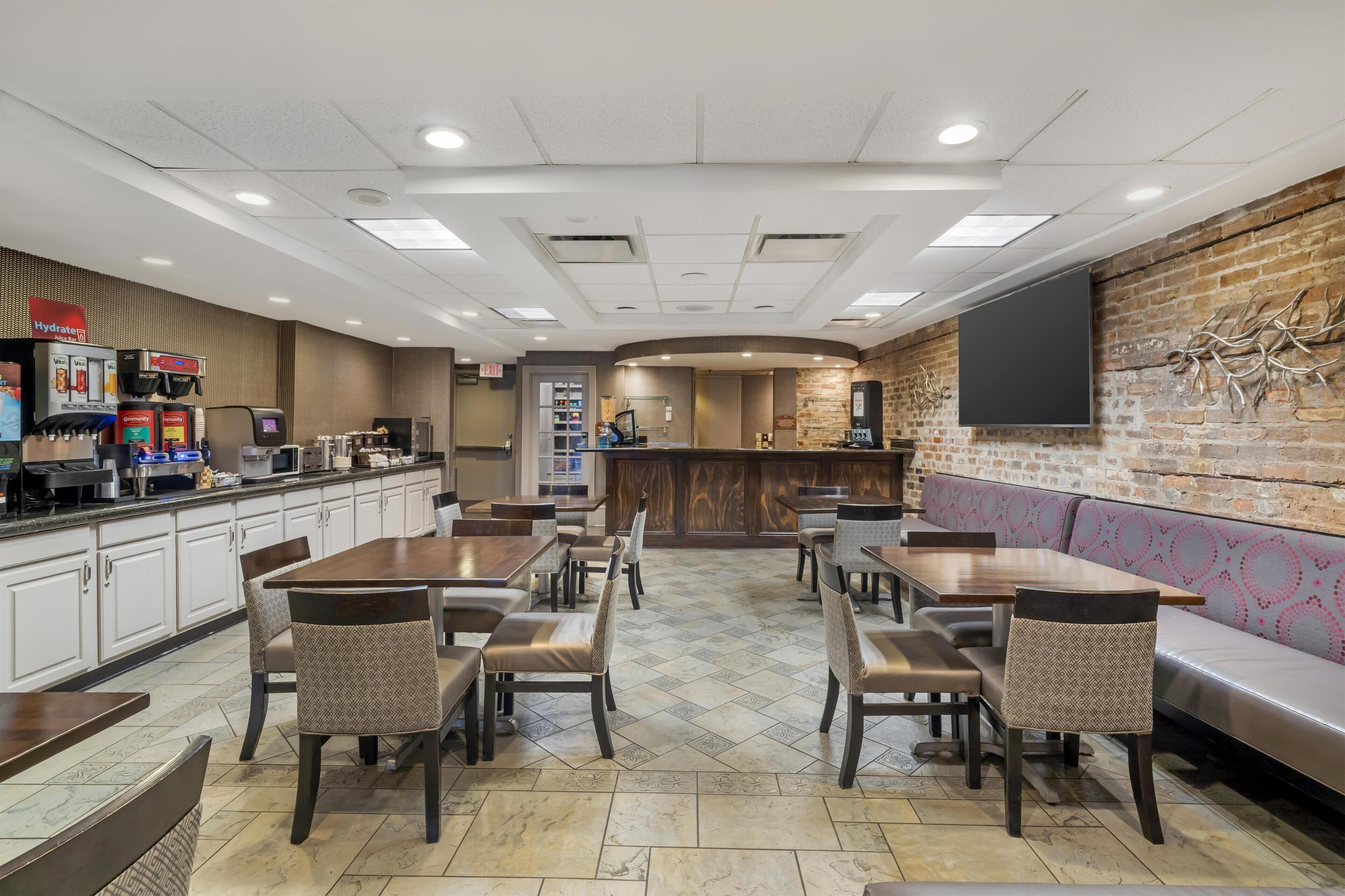 A restaurant with booths, tables, and a bar area.