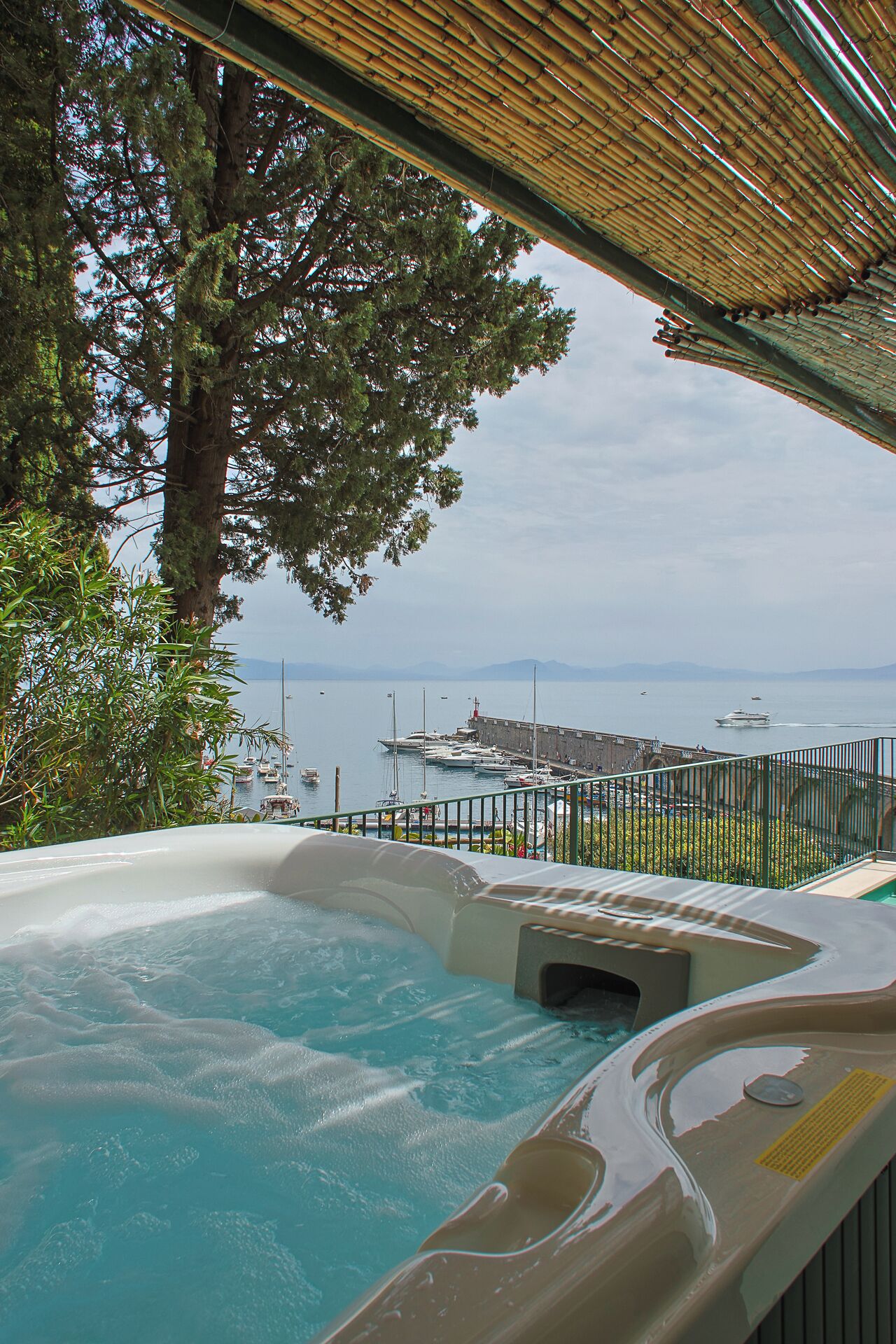 A hot tub with a view of a marina and boats.