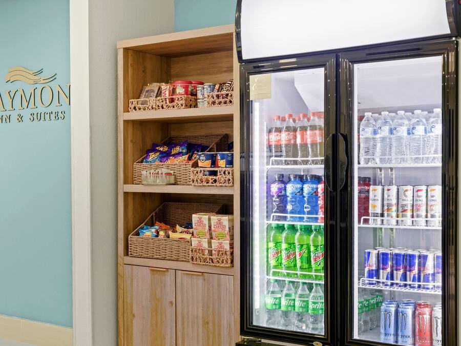 A refrigerated display case with various beverages and snacks.