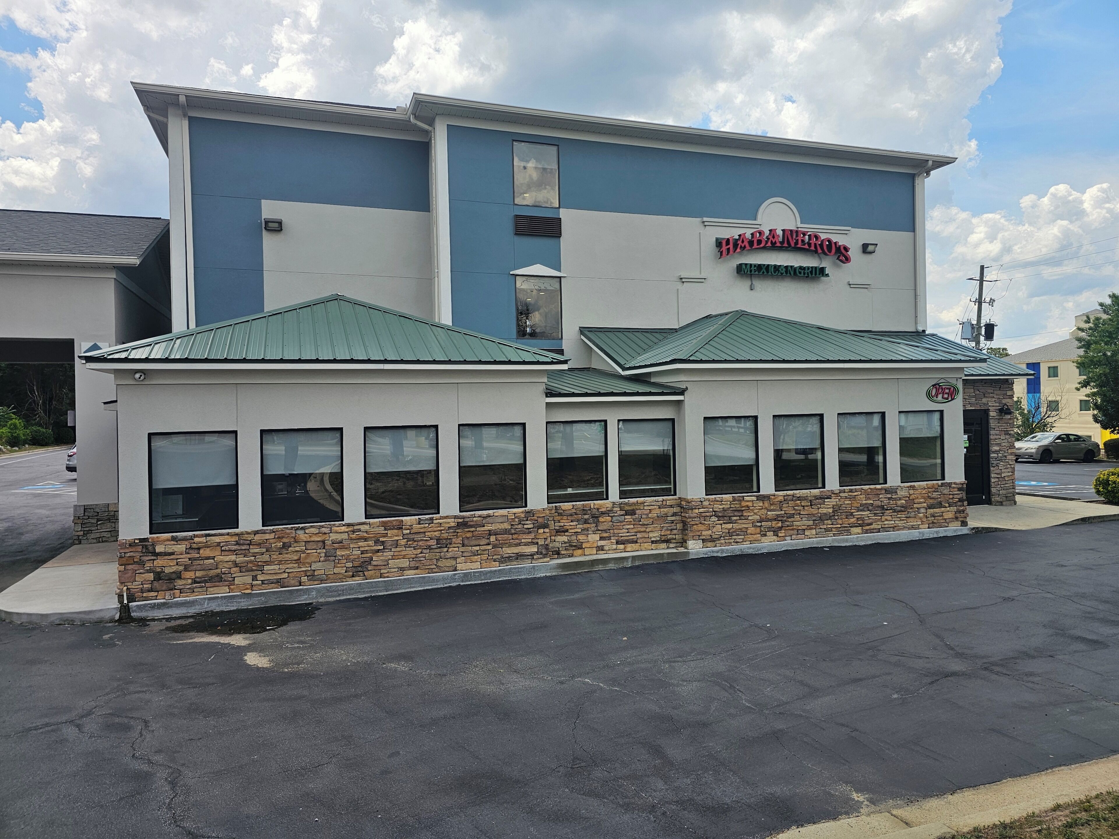 A restaurant named 'Habaneiros Mexican Grill' with a stone facade and green roof.