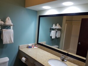 A bathroom with a sink, mirror, towel rack, and toilet. - Baymont by Wyndham Grovetown Augusta (Grovetown)