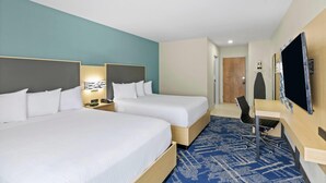 A hotel room with two beds, a desk, a chair, a flat-screen TV, and a wardrobe. - Baymont by Wyndham Grovetown Augusta (Grovetown)
