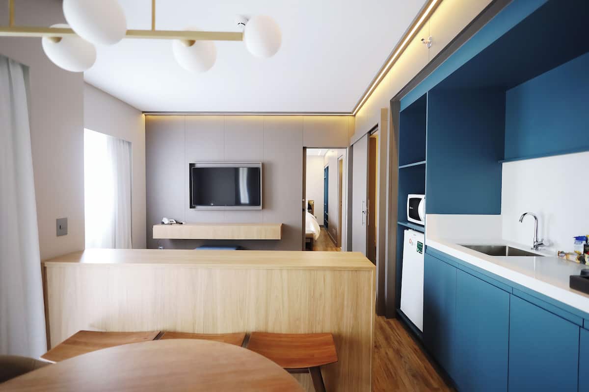A modern kitchen with a built-in microwave, a sink, and a countertop.