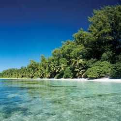 On the beach, white sand, sun-loungers, beach umbrellas