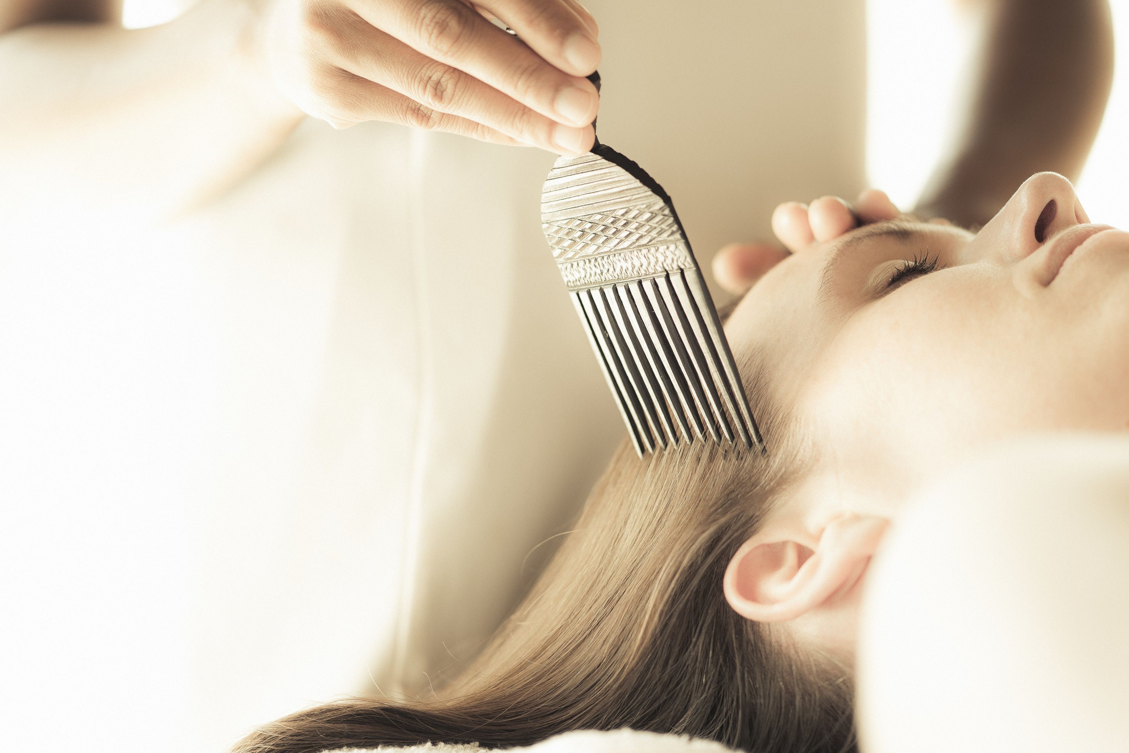 A person receiving a hair treatment.