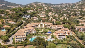 A large resort with multiple buildings, a central pool area, and surrounding greenery. - Pierre & Vacances Les Rivages des Issambres (Roquebrune-sur-Argens)