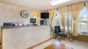 A reception area with a desk, computer, printer, and a chair. - Americas Best Value Inn Wytheville (Wytheville)
