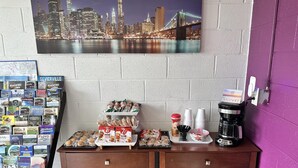 A counter with snacks, coffee, and a map display. - Americas Best Value Inn Wytheville (Wytheville)