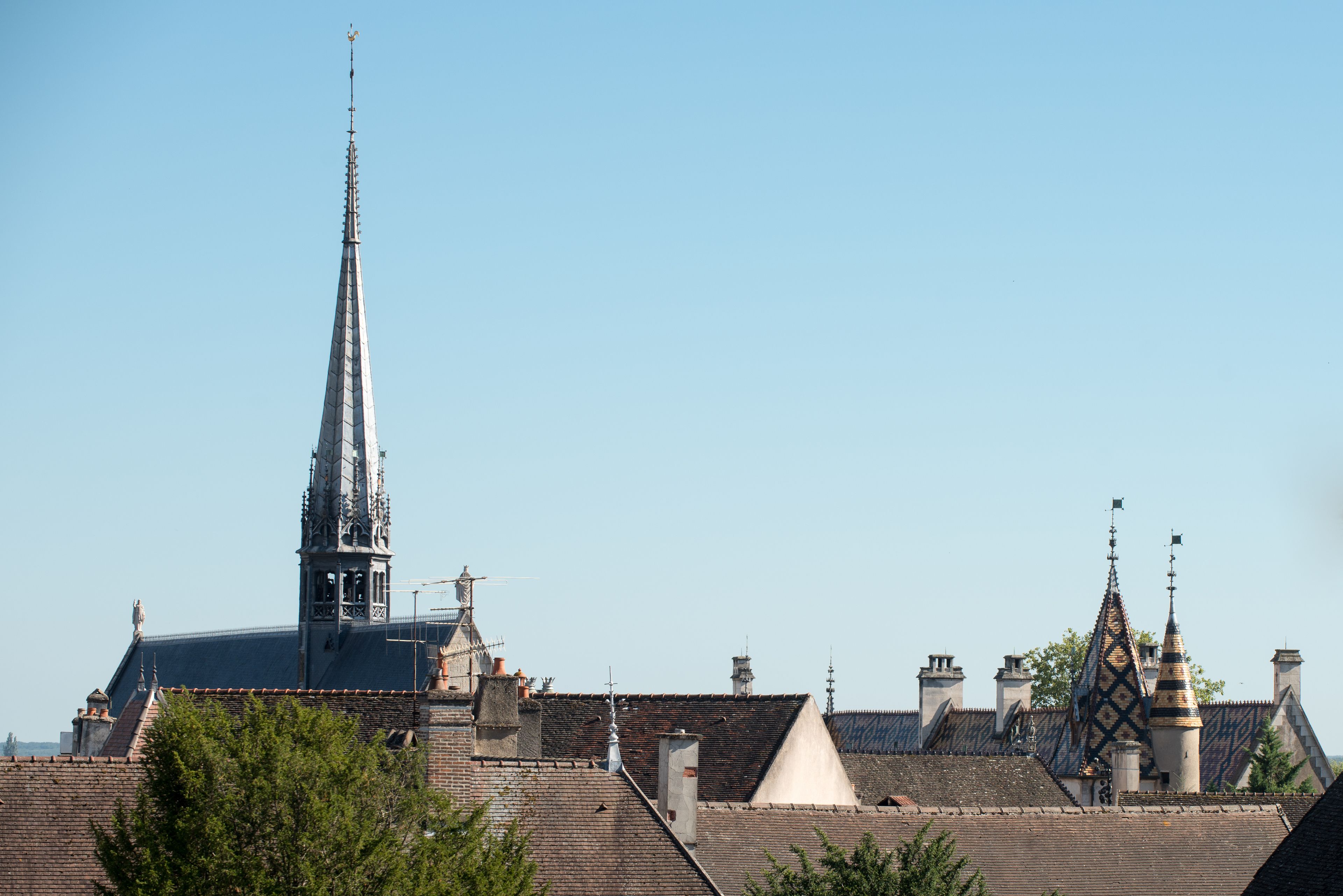 A church with a tall spire and a bell tower.