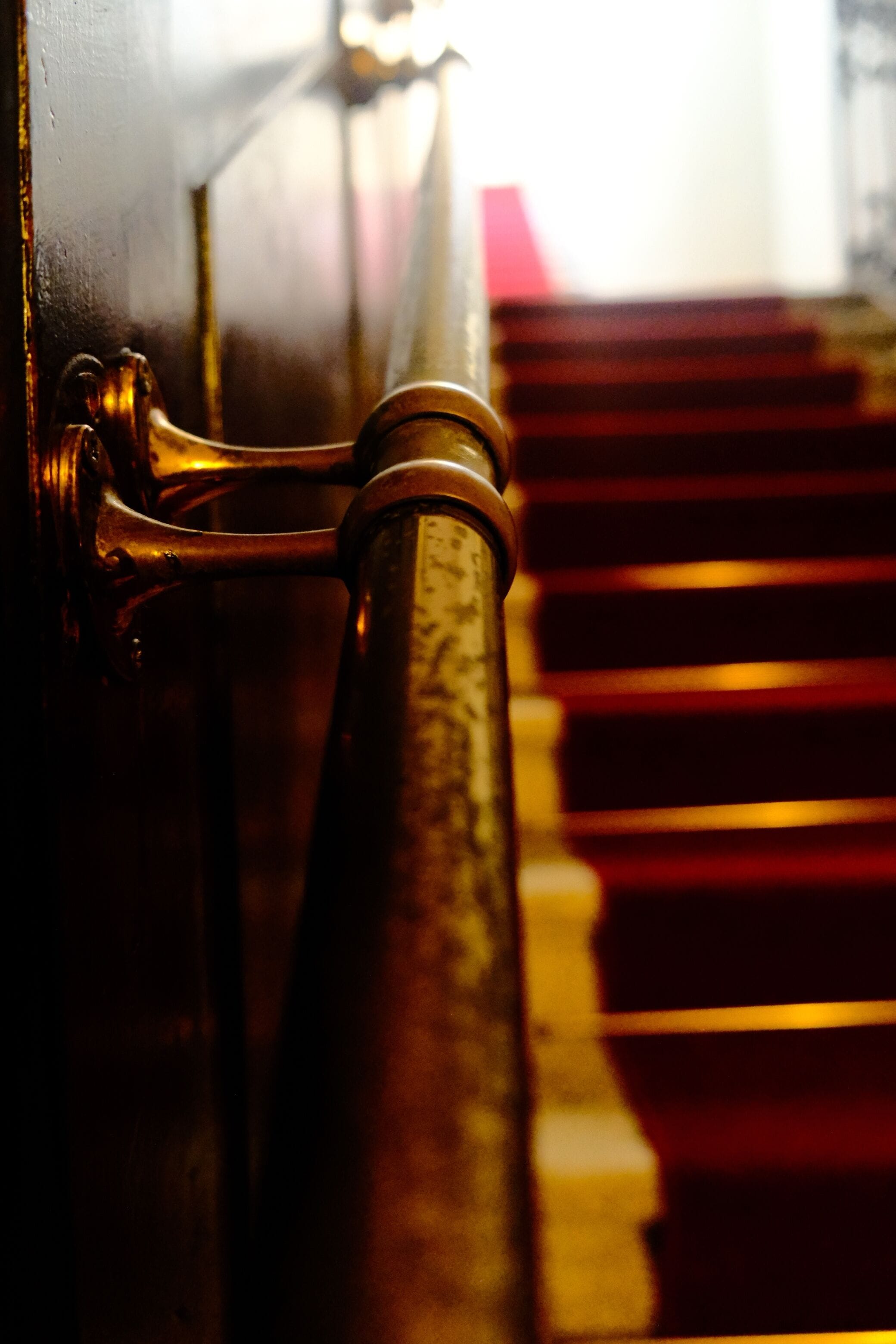 A close-up of a brass door handle and a wooden door.