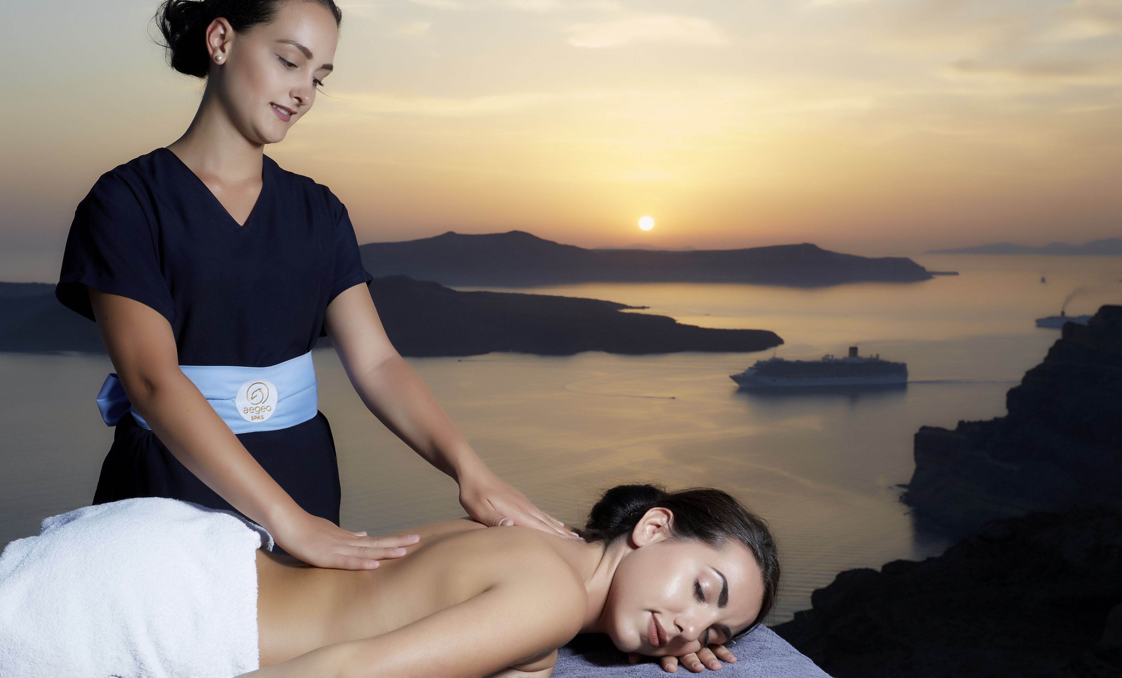 A spa setting with a person receiving a back massage.