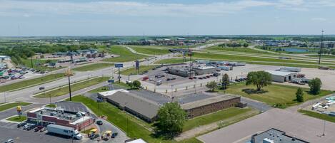 A commercial area with a McDonald's, a parking lot, and a large building with a flat roof.