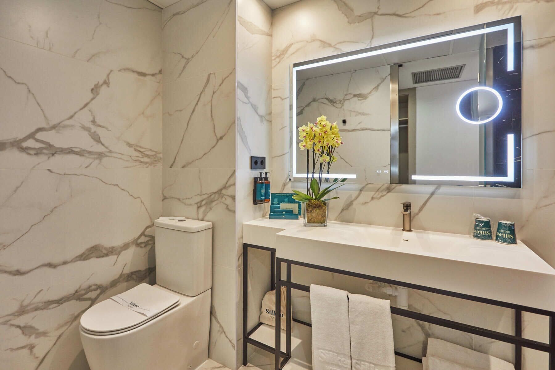 shower, designer toiletries, hair dryer, towels