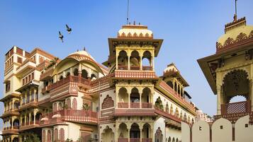 A traditional building with multiple balconies and arches, featuring intricate architectural details.