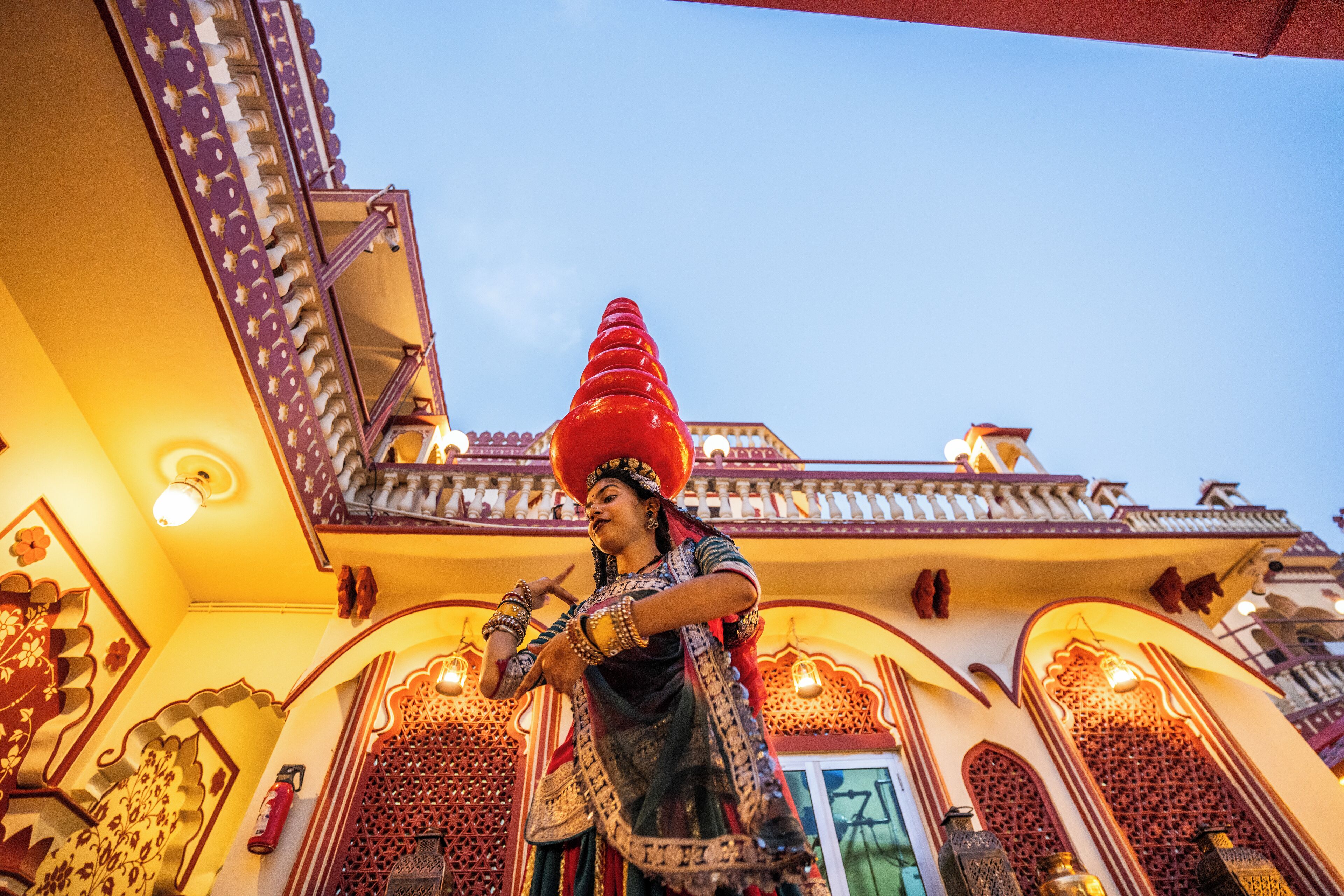 A traditional building with ornate architectural details and a person in traditional attire.