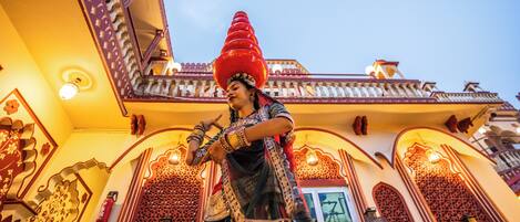 A traditional building with ornate architectural details and a person in traditional attire.