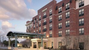 A multi-story brick building with a sign reading "Courtyard by Marriott."