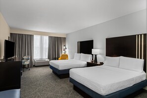A hotel room with two beds, a desk, a chair, a TV, and a window with curtains. - Hampton Inn & Suites Mountain View (Mountain View)