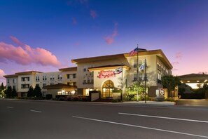 A hotel with a prominent sign, multiple floors, and a flag. - Hampton Inn & Suites Mountain View (Mountain View)