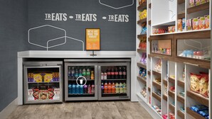 A snack display with multiple shelves and refrigerated sections.
