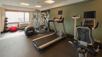 A fitness center with treadmills, a stationary bike, and a rowing machine.