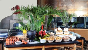 A buffet table with various food items, including fruits, bread, and pastries, and a coffee machine in the background. - Holiday Inn Sao Paulo Parque Anhembi by IHG (São Paulo)