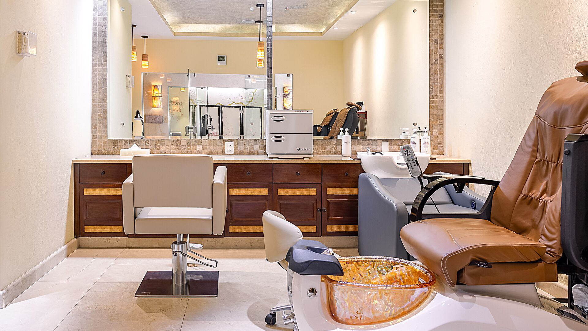 A modern bathroom with a large mirror, a hairdryer, a chair, and a bowl of fruit.