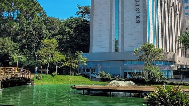 A modern hotel building with a prominent name sign, a landscaped garden, and a water feature. - Bristol Santo André Hotel (Santo André)