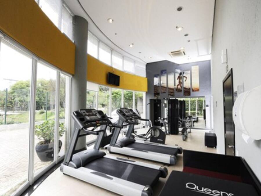 A gym with treadmills, exercise bikes, and weight machines.