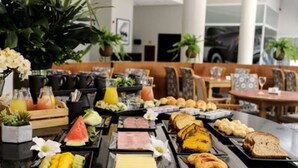 A buffet with various food items and beverages.