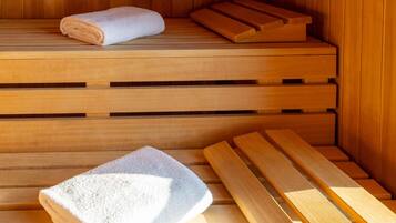 A sauna with wooden benches and a towel.