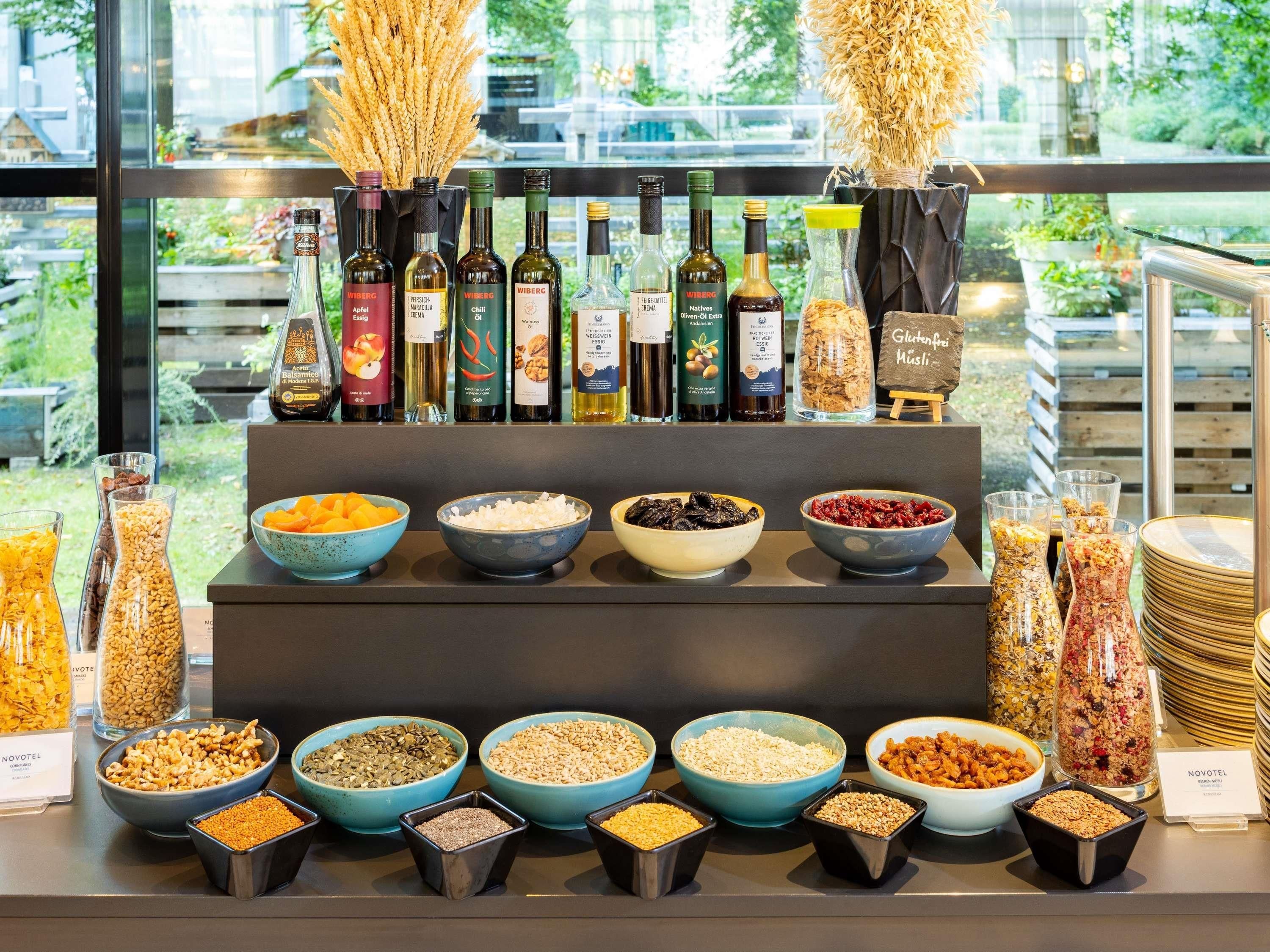 A buffet with various food items and wine bottles.