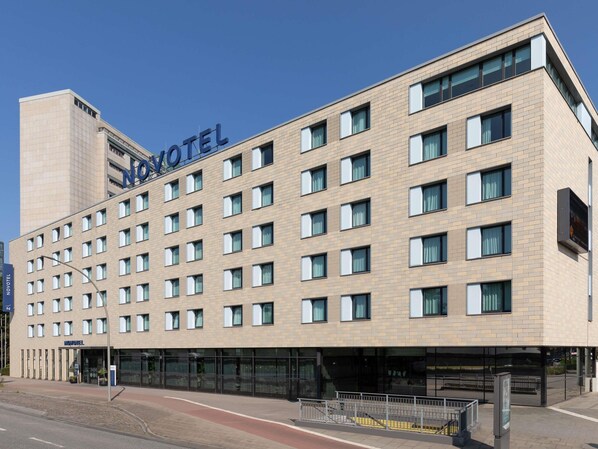 A hotel with a modern design, featuring a flat roof and a series of windows.