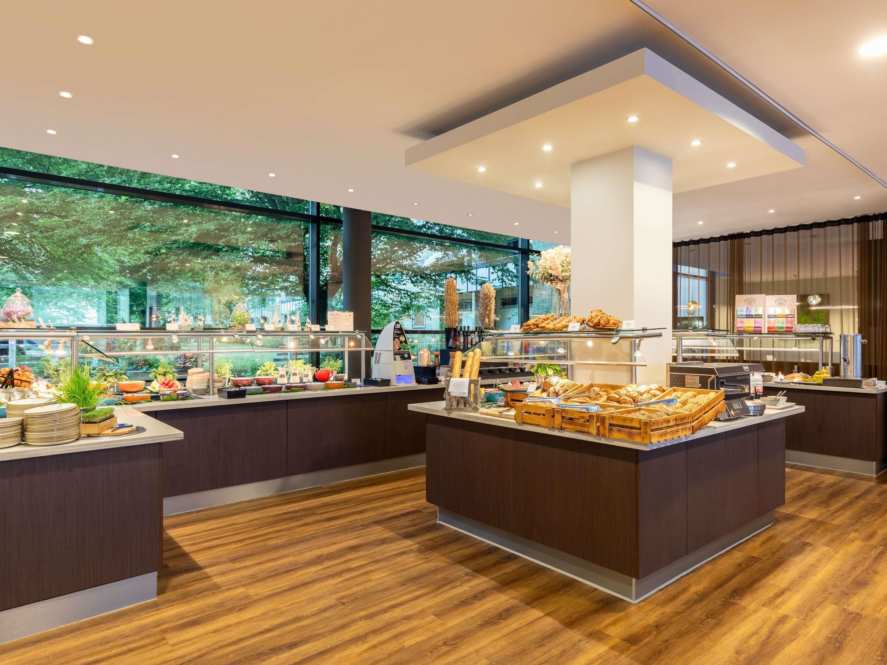 A modern breakfast buffet with various food items and a coffee station.