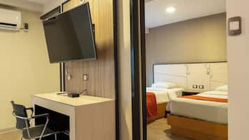 Family Room | Minibar, in-room safe, desk, blackout drapes