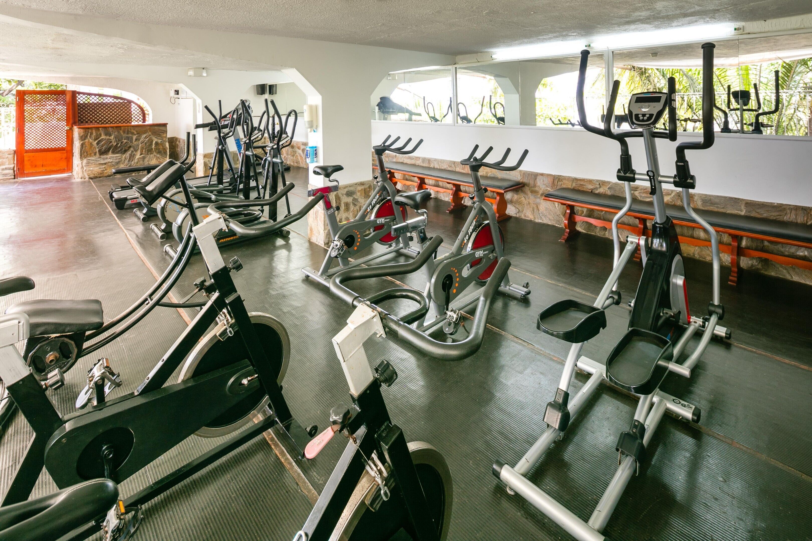 A gym with stationary bikes, treadmills, and exercise equipment.