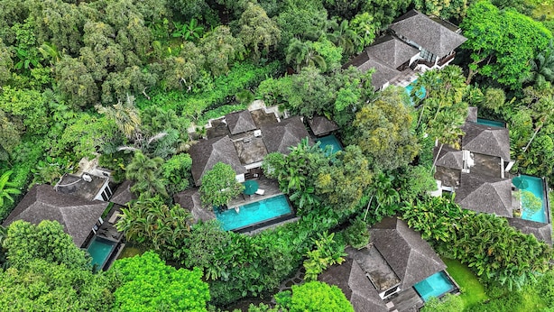 An aerial view of a resort with multiple houses, each with a swimming pool surrounded by lush greenery. - The Damai (Sukasada)