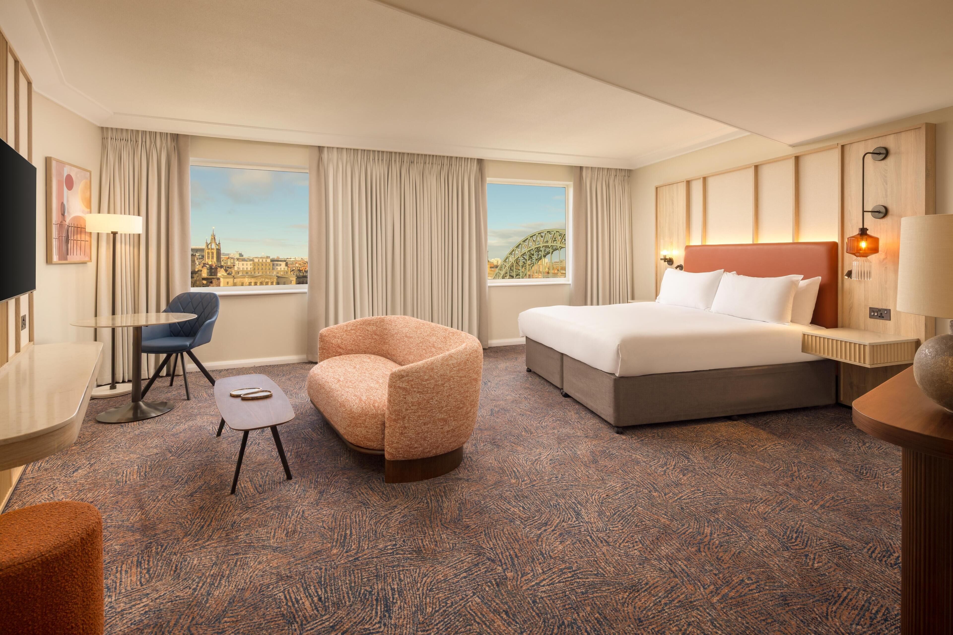 Junior Suite, 1 King Bed | Living area | 55-inch flat-screen TV with satellite channels, TV