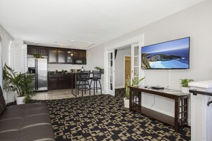 Suite, 1 King Bed with Sofa bed, Balcony | Living area | Flat-screen TV