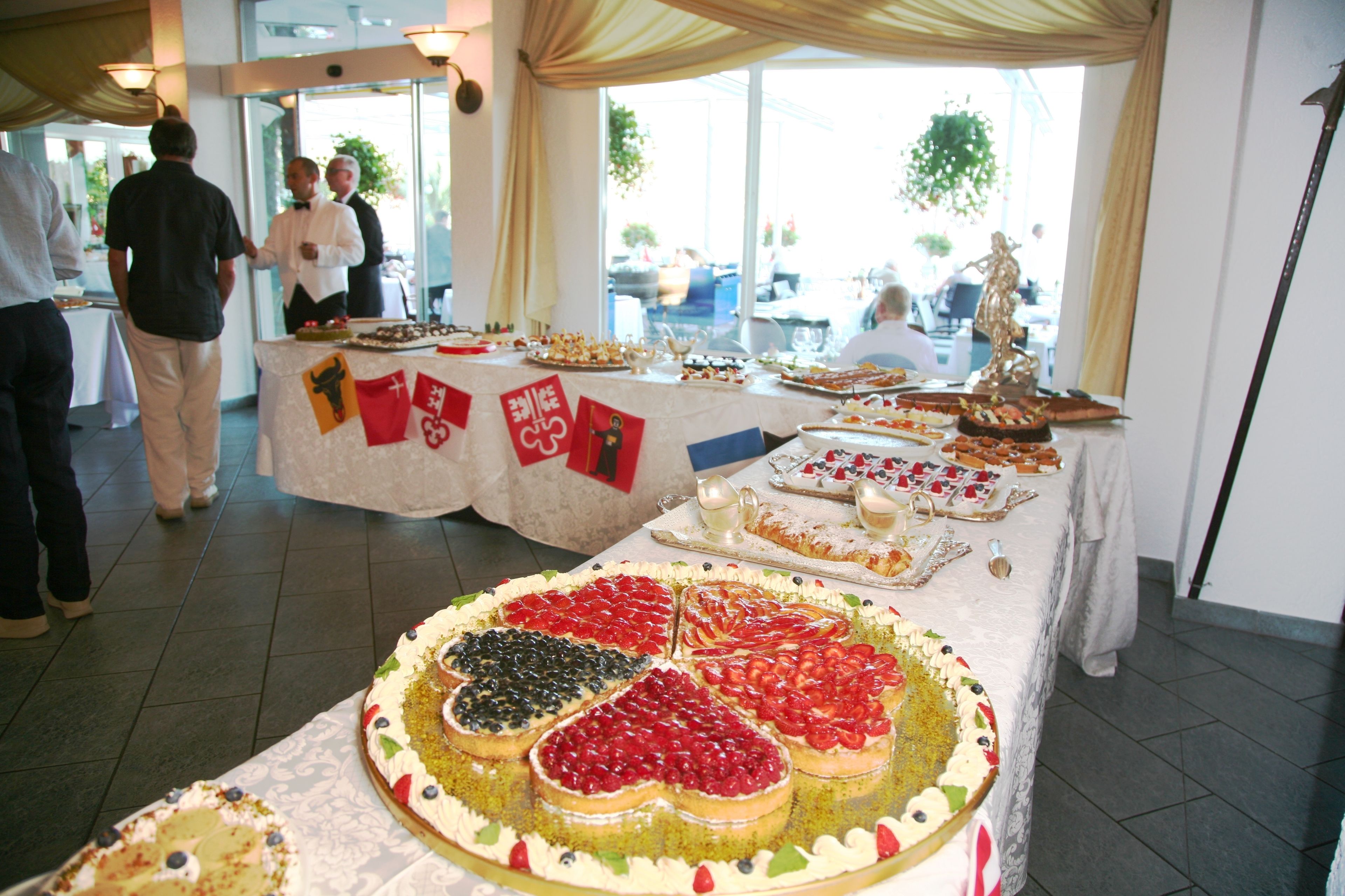 Ein Buffet mit verschiedenen Desserts und einer Kuchen mit Frucht-Dekoration.