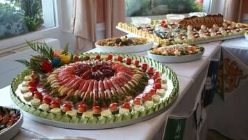 A buffet table with various food items arranged in a circular pattern.