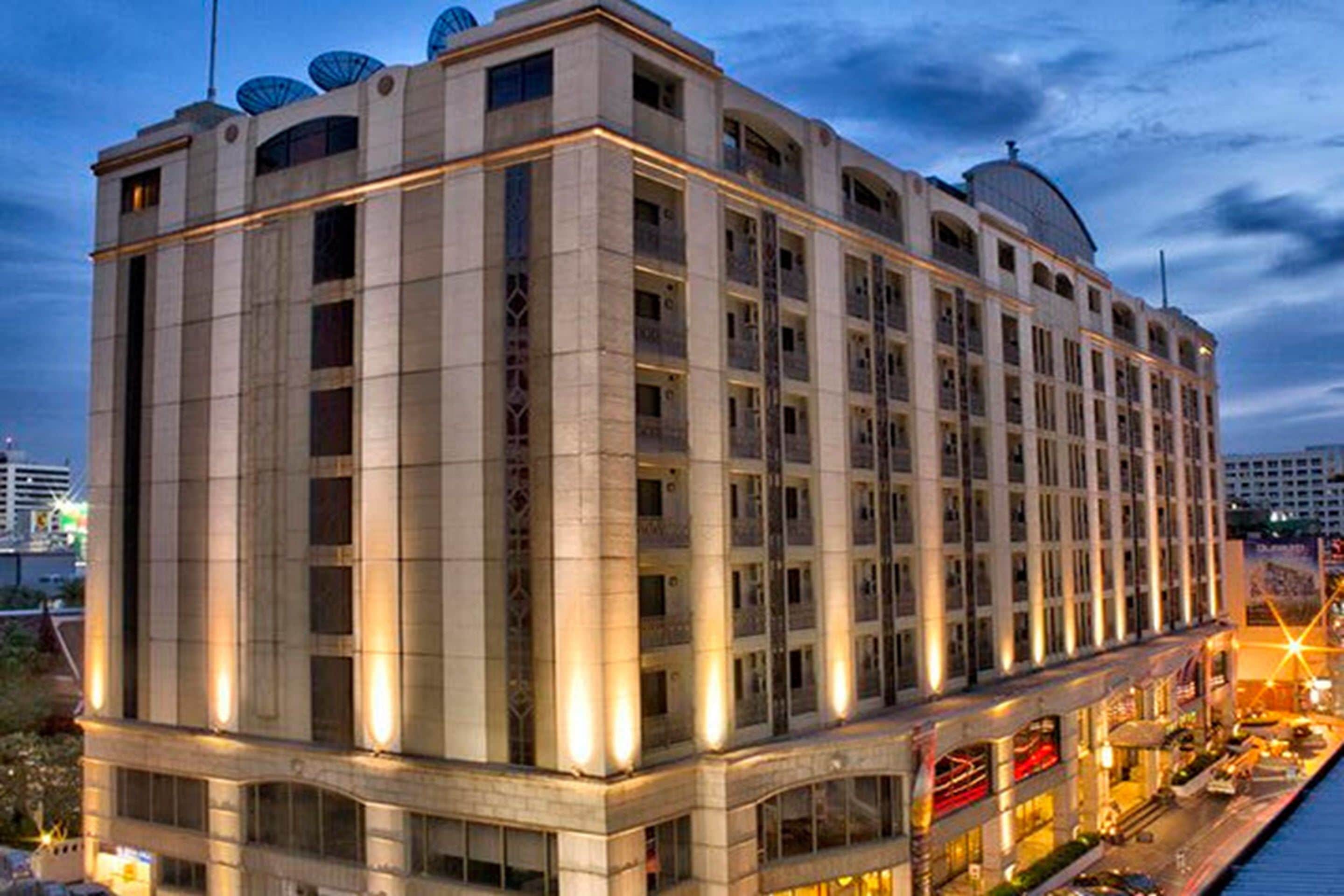 A multi-story hotel with a classic architectural style, featuring a symmetrical facade and large windows.