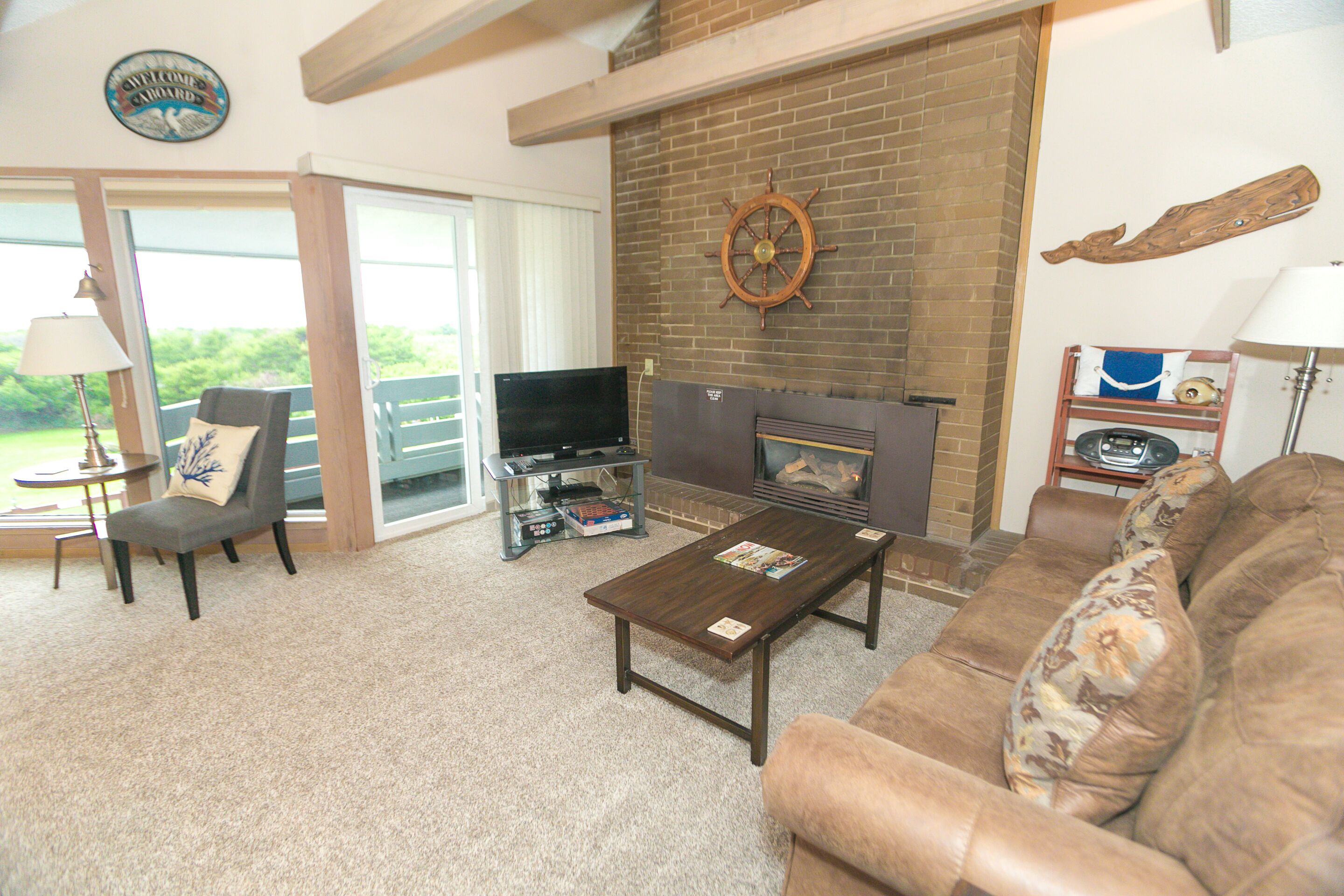 A living room with a fireplace, a television, a sofa, and a coffee table.